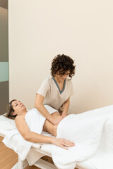 A therapist giving abdominal massage in female patient