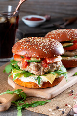 Homemade juicy burgers with beef, cheese and arugula on a table. American cuisine. Fast food