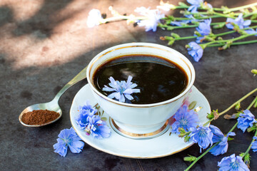 Healthy chicory drink in cup decorated chicory flowers.Herbal beverage, coffee substitute.
