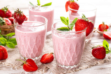 Strawberry milkshake in the glass jar. Smoothie and fresh strawberries. Healthy food and drink...