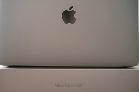 Gelendzhik, Russia, 17 February 2022: Notebook Apple Macbook Air 13 M1 silver stands on top of the box with the inscription of the model. Rear view with open lid.
