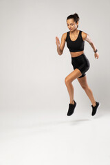 Full length photo of lady jump high up training marathon finish line wear sports suit isolated white background