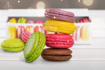 French dessert for coffee. Multicolored macarons or macaroons on desk