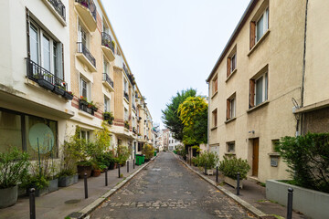 Fototapeta na wymiar Paris, France - November 15th 2021: Quiet housing area without parked cars on the residential street.