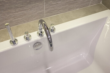 closeup faucet on bathtub