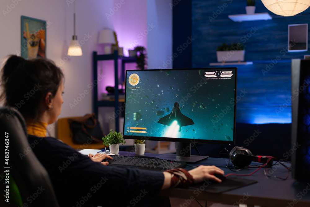 Poster person using keyboard and mouse to play video games on computer. gamer playing online game in front 