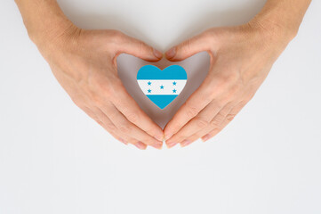 The national flag of Honduras in female hands.