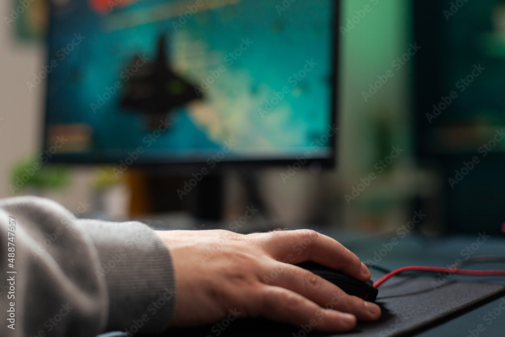 Poster close up of player holding mouse with mousepad on desk to play video games. man using gaming equipme