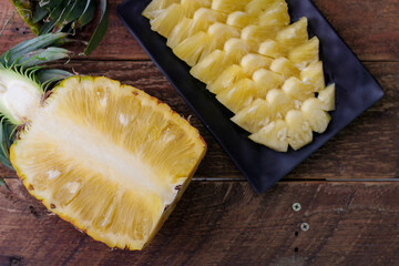 Top view Pineapple slices and pineapple shelled Asian-style on the wooden background.