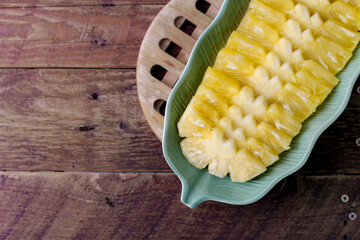Top view Pineapple slices Asian-style on the wooden background.
