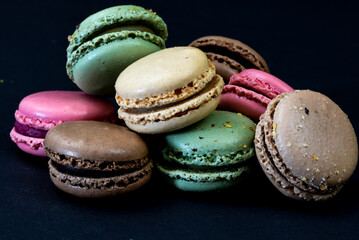 The Netherlands. January 2022. Close up of colorful macarons against a black background.