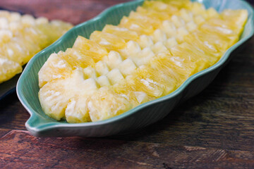 Pineapple slices Asian-style on the wooden background.