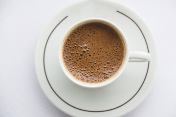close-up of coffee cup full of coffee and white background. hot fresh turkish coffee