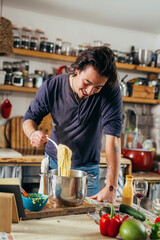 man preparing spaghetti at home