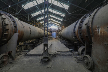 Fototapeta na wymiar he idle and abandoned cement rotary kiln is in a factory, North China