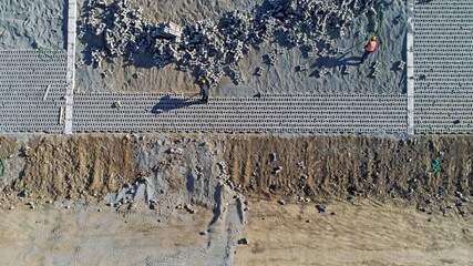 Workers are building river slope protection at a water conservancy project construction site, North...