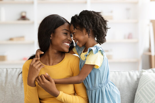 Loving African American Mother And Little Daughter Laughing And Bonding At Home