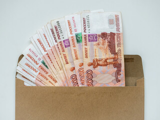 Money in envelope on white background. Cash in envelope. Russian roubles. RUB. Russian money in envelope. Savings. Bribery and corruption. Bribe in envelope. Russian money. Money laundering