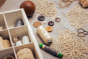 Sewing supplies on a wood table - 488755015