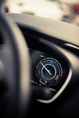Digital dashboard of a new car, showing power and charge
