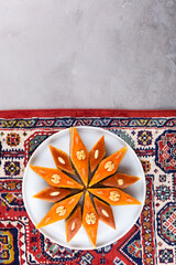 Plate of Azerbaijani national pastries for Novruz - Ganja and Baku style pakhlava on silk scarf kelagai for Novruz, spring equinox and new year celebration in March. Copy space  