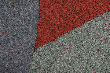 Soft rubber play ground floor surface in grey, red and beige colour background. Outdoor gym for...