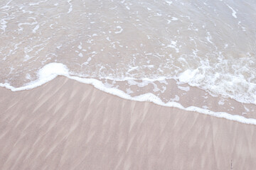 Seaside baltic sea coast view with small wave bubbles.