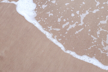 Seaside baltic sea coast view with small wave bubbles.
