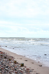 Fototapeta na wymiar Coastal shore view with baltic sea and rocks on sand.