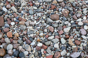 Close up photography view with small and large rocks on a beach.