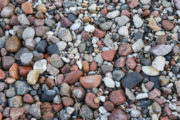 Close up photography view with small and large rocks on a beach.
