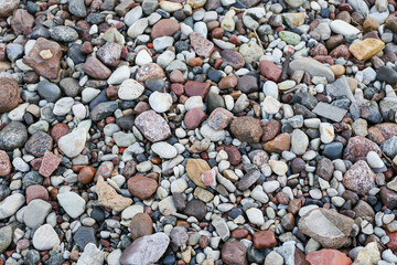Close up photography view with small and large rocks on a beach.