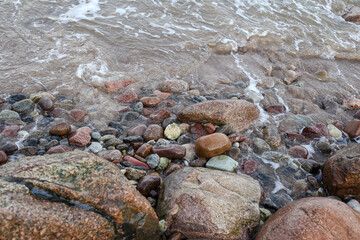 Seaside coast view with large and small rocks near Baltic Sea.