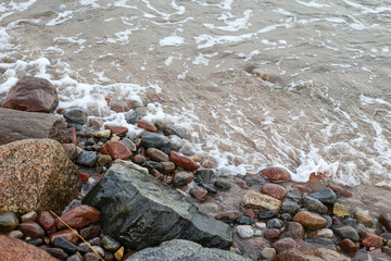Seaside coast view with large and small rocks near Baltic Sea.