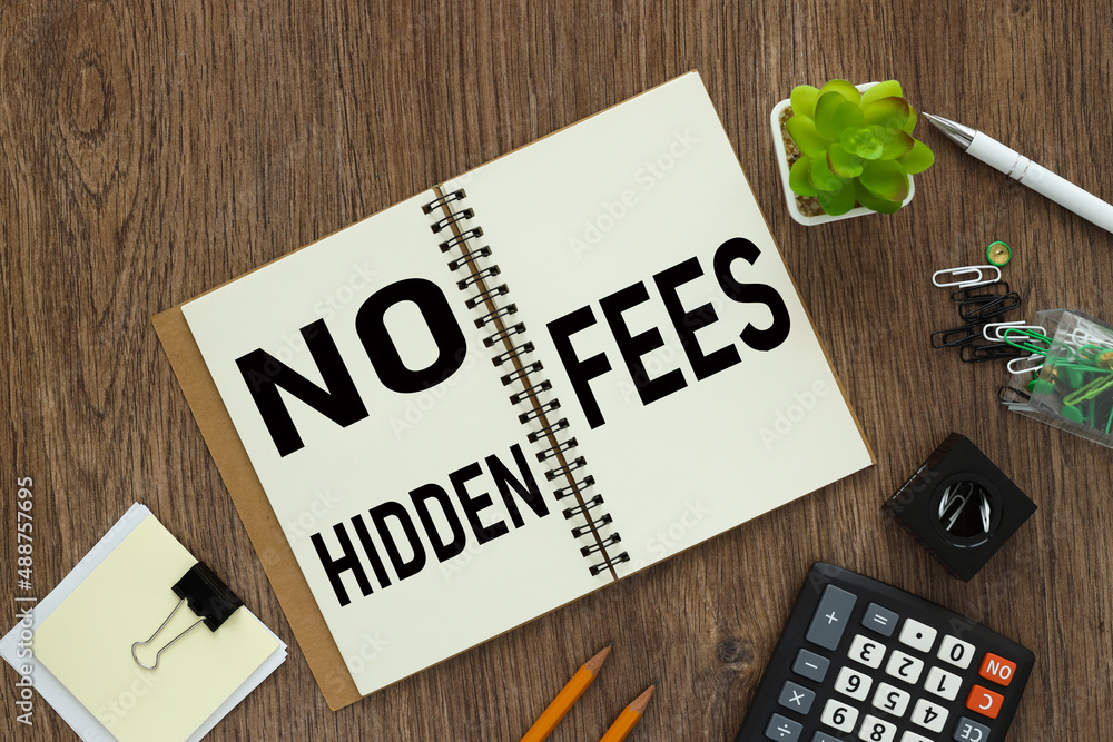 Aufkleber no hidden fees. text on an open notepad. on a wooden work table