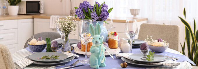 Beautiful dining table served for Easter celebration in kitchen