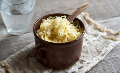 Fermented cabbage or sauerkraut on a wooden table