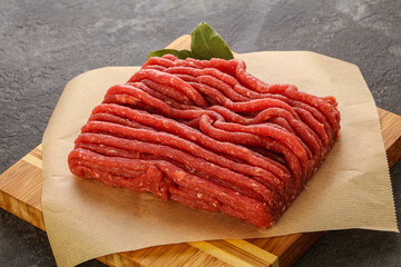 Raw beef minced meat over board
