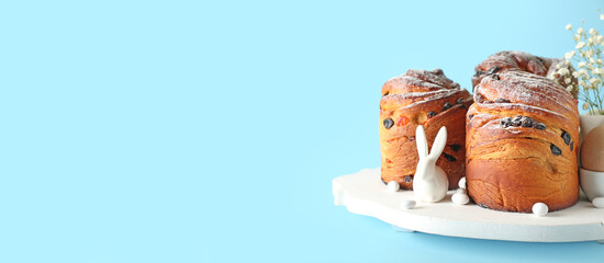 Delicious Easter cakes on blue background with space for text