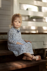 little girl sitting on the stairs