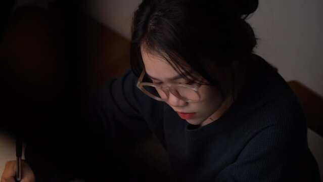 A young Vietnamese girl is typing on her computer