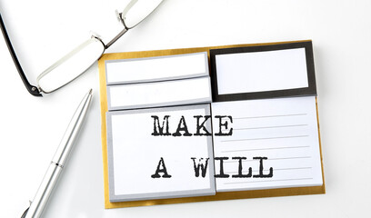 MAKE A WILL text on sticky notes with glasses and pen, business concept