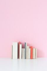 Obraz premium Old Books against pink wall.