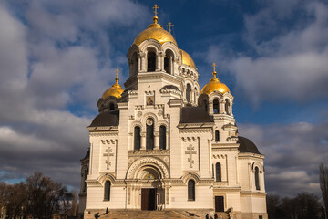 Orthodox church with golden domes and crosses against a clear blue sky with clouds. view of the Ascension Cathedral in the town of Novocherkassk.Russia.