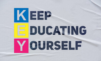 keep educating yourself, (KEY), written on white paper