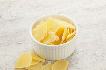 Sliced parmesan cheese heap in the bowl