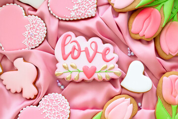 background banner greeting card for international women day or valentines day with white heart love, tulips and pigeon shape gingerbread cookies on silk fabric background
