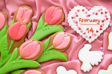 background banner greeting card for 14 february Valentines day with white and pink heart, tulips and pigeon shape gingerbread cookies on pink silk fabric background