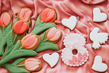 background banner greeting card for international women day with eight number, tulips and pigeon shape gingerbread cookies on pink silk fabric background