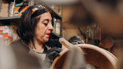 woman working wood in craft workshop
